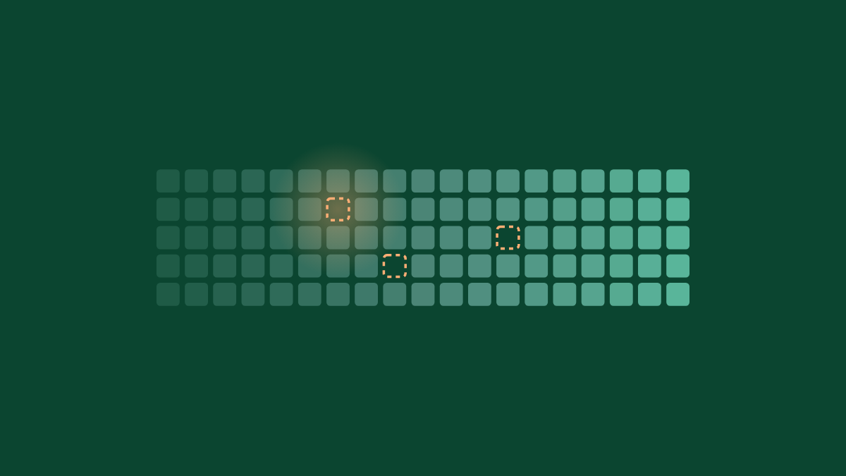 A band of green tiles with three empty places outlined in peach