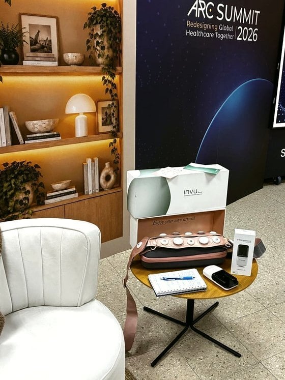 The Sheba Beyond Hospital at Home station: an armchair, a bookshelf and the INVU kit on a side table